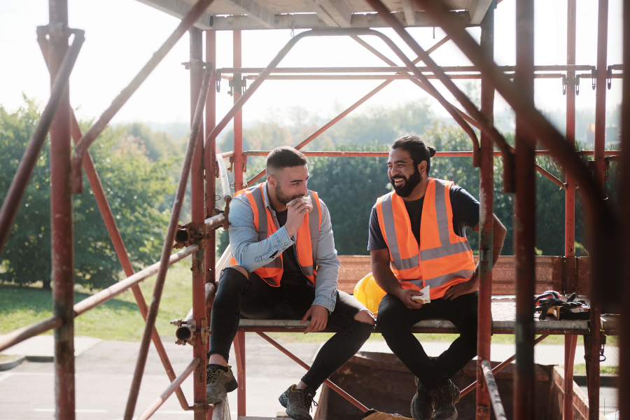 two men working construction taking a lunch break